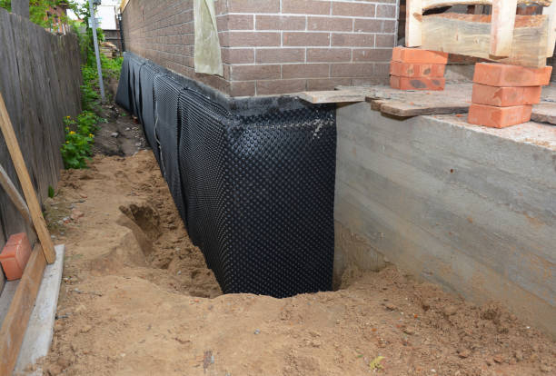 Happy homeowners after waterproofing job in West Newton
